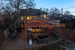 Back of house featuring a patio, a fenced backyard, stairs, and an outdoor fire pit