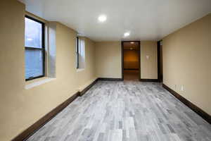 Spare room with light wood-style flooring and recessed lighting