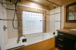 Bathroom featuring vanity and tiled shower / bath combo