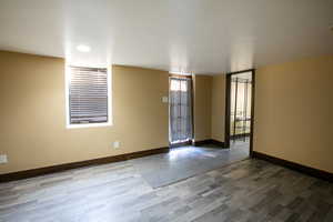 Unfurnished room featuring baseboards and wood finished floors