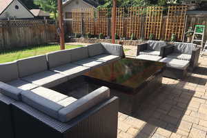 Fenced backyard with outdoor lounge area and a patio