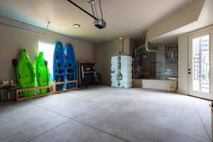 Garage with a garage door opener. Shows fire suppression system, ping pong table  and water toys.
