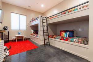 Bedroom featuring concrete flooring and recessed lighting