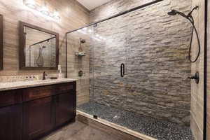 Bathroom featuring vanity and a stall shower