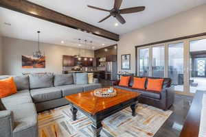 Living area with beamed ceiling, recessed lighting, and a ceiling fan