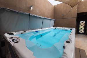 View of swim spa  in protected shaded court area