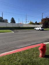 View of asphalt street featuring street lighting and curbs