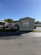 Manufactured / mobile home with covered porch and a shed
