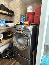 Laundry room featuring dark wood-style floors, washer / dryer, and wallpapered walls