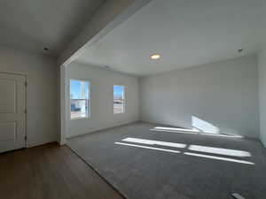 Empty room with a textured ceiling and wood finished floors