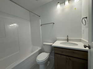 Full bath featuring vanity, shower / washtub combination, and a textured ceiling