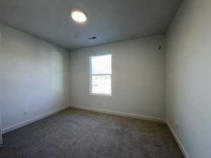 Spare room with carpet floors and baseboards