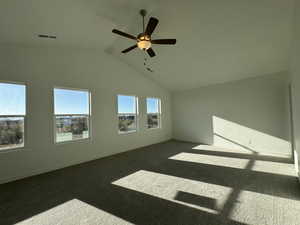 Unfurnished room featuring carpet flooring, a ceiling fan, and high vaulted ceiling