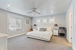Bedroom with multiple windows, carpet floors, recessed lighting, a ceiling fan, and a textured ceiling