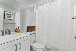 Full bath featuring vanity and shower / bath combination with curtain
