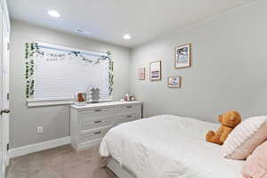 Bedroom featuring light carpet and recessed lighting