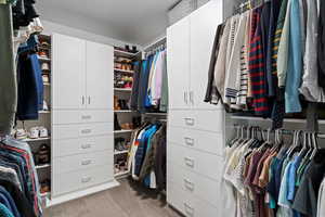 Walk in closet with light carpet