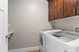 Laundry room with washer and dryer and cabinet space