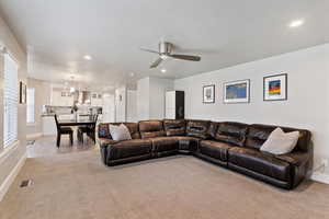 Living area featuring light colored carpet, recessed lighting, and ceiling fan