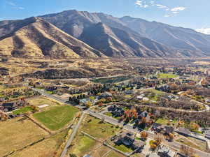 Aerial view of property's location featuring a mountainous background and nearby suburban area