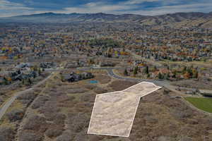 Aerial view of property's location featuring property boundaries highlighted and nearby suburban area
