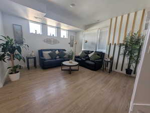 Living room featuring light wood finished floors and a textured ceiling