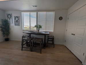 Dining space featuring light wood-style floors and a textured ceiling