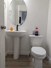 Half bathroom featuring baseboards and light wood-type flooring