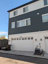 View of side of home with board and batten siding and an attached garage