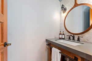 Bathroom with decorative backsplash and a sink