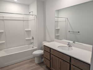 Bathroom with vanity, light wood-style flooring, and bathtub / shower combination