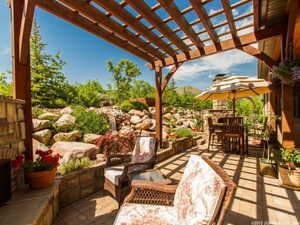 View of patio featuring a pergola and outdoor dining area