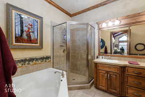 Full bathroom with ornamental molding, a bath, vanity, a shower stall, and light tile patterned floors