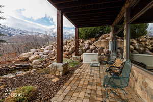 View of patio with a small pond and a mountain view