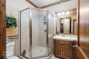 Full bath with vanity, a stall shower, and light tile patterned floors