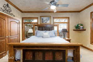 Bedroom featuring a closet, crown molding, a ceiling fan, and carpet flooring