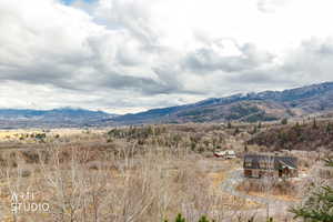 View of mountain backdrop featuring rural landscape