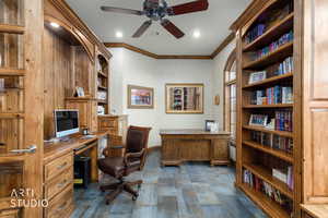 Office area featuring built in study area, ornamental molding, and ceiling fan