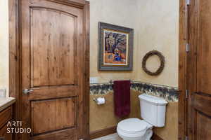 Bathroom with vanity, wallpapered walls, and tile patterned floors