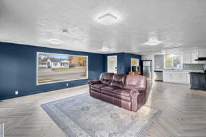 Cinema room featuring baseboards and a textured ceiling