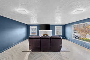 Living area featuring a fireplace and a textured ceiling