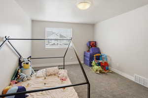Bedroom with light carpet and baseboards
