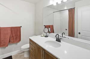 Bathroom with vanity, a shower with shower curtain, and light tile patterned flooring