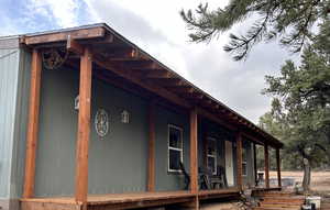 View of side of property with a porch