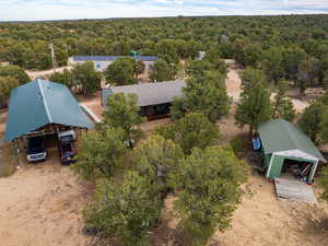 Aerial view of property and surrounding area featuring a heavily wooded area