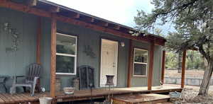 Entrance to property featuring covered porch