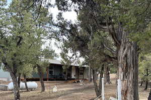 View of front of home featuring a porch and a shingled roof