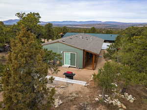 Aerial view of property and surrounding area featuring a mountain backdrop