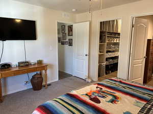 Bedroom featuring light colored carpet and baseboards