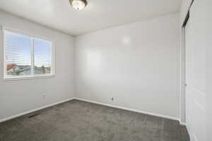 Unfurnished room with carpet flooring and baseboards